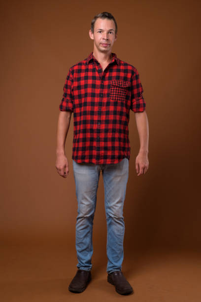 istock Studio shot of man wearing red checkered shirt against colored background 856133524