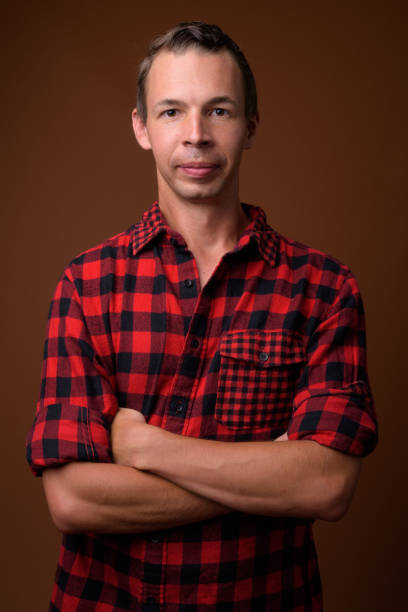 istock Studio shot of man wearing red checkered shirt against colored background 856133612