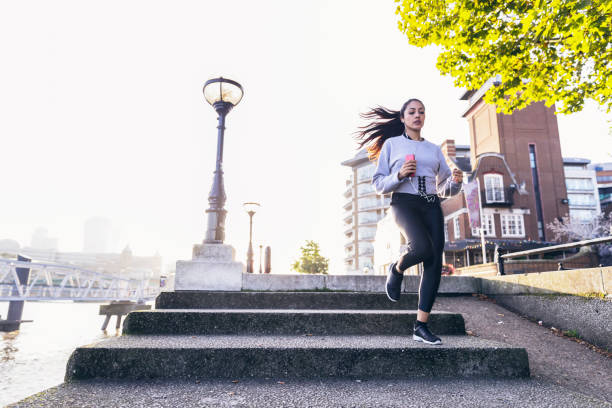 istock Jogging up and down the steps to keep rhythm with the music and workout 856134750