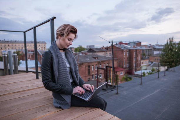 istock Girl work on laptop on the roof 856144988