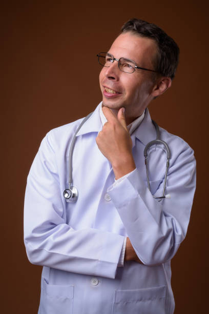istock Studio shot of man doctor wearing eyeglasses against colored background 856147970