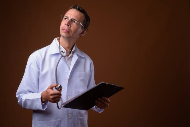 istock Studio shot of man doctor wearing eyeglasses against colored background 856148364