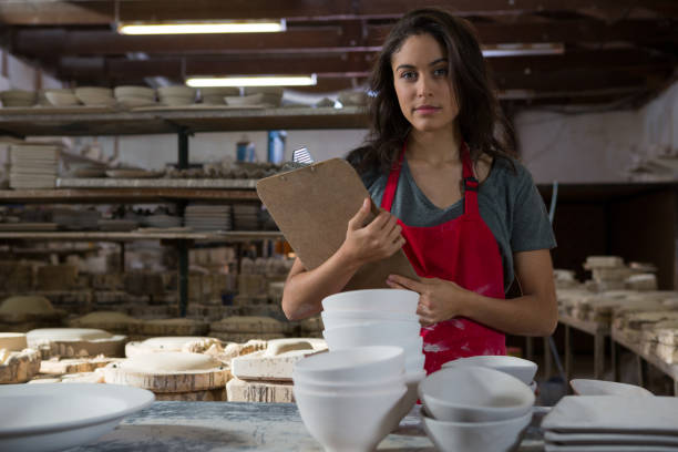 istock Confident female potter standing with clipboard 856148594