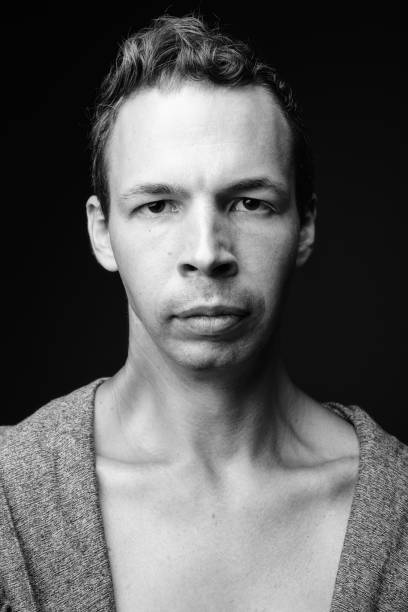 istock Studio shot of rebellious man against black background 856148760