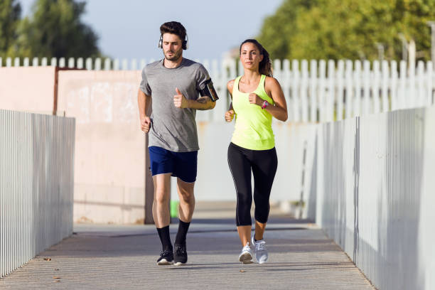 istock Beautiful couple running in the street. 856148916