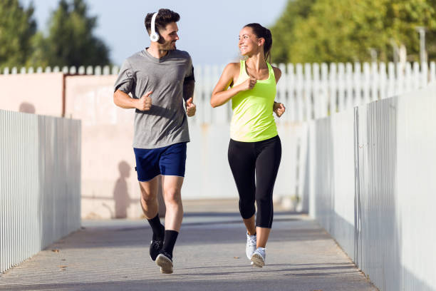 istock Beautiful couple running in the street. 856149078