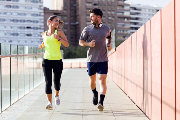 istock Beautiful couple running in the street. 856149256