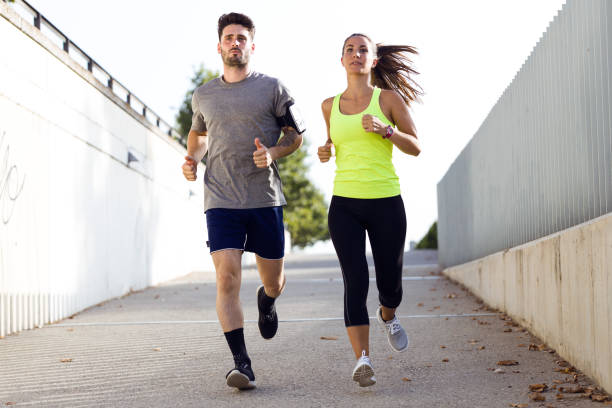 istock Beautiful couple running in the street. 856149322