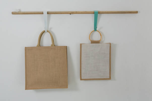 istock Two bags hanging on wooden rod 856162368