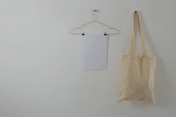 istock Paper and bag hanging against white wall 856162942