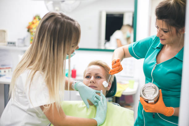istock Young woman is getting a collage injection in her face. 856163662