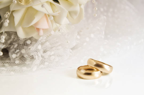 istock Wedding rings and bridal bouquet on a light background. 856164146