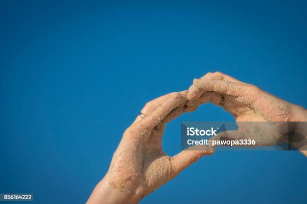 Hands Covered In Beach Sand Making A Heart Shape Stock Photo - Download Image Now - Adult, Beach, Beauty