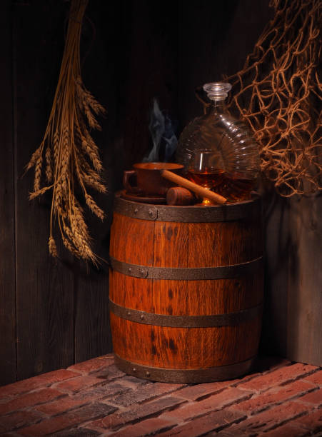 istock Glass of cognac with barrel in cozy cellar 856166906