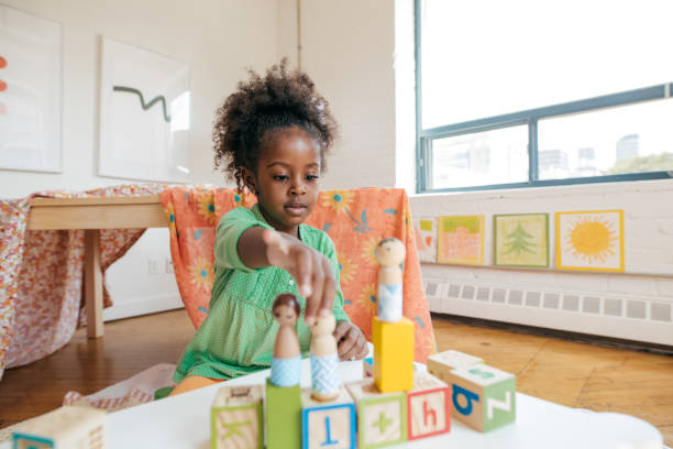istock Girl playing with wooden blocks 856171196