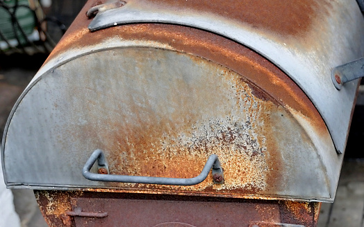 Age smoker, close-up of the rusty firebox of the grill device
