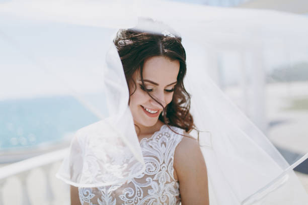 istock Beautiful brunette bride on a walk by the sea 856174460