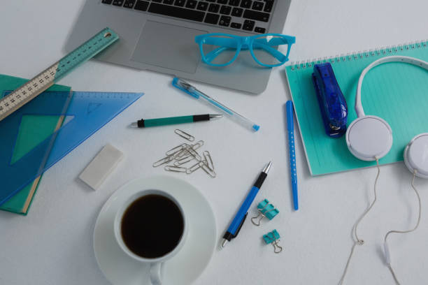 istock Laptop, black coffee and stationery on white background 856174730