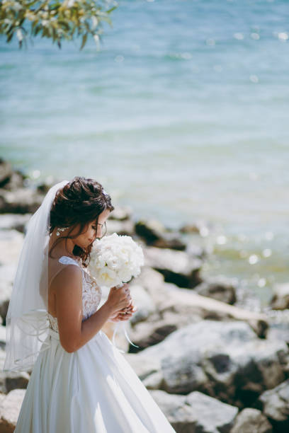istock Beautiful brunette bride on a walk by the sea 856177144