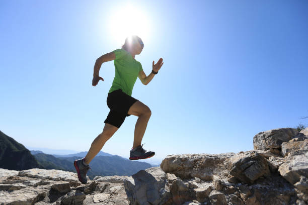 istock woman trail runner running at mountain top 856178858
