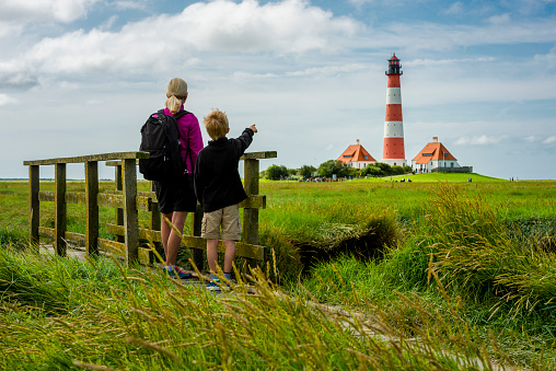 woman and boy looking to lighthouse Westerhever