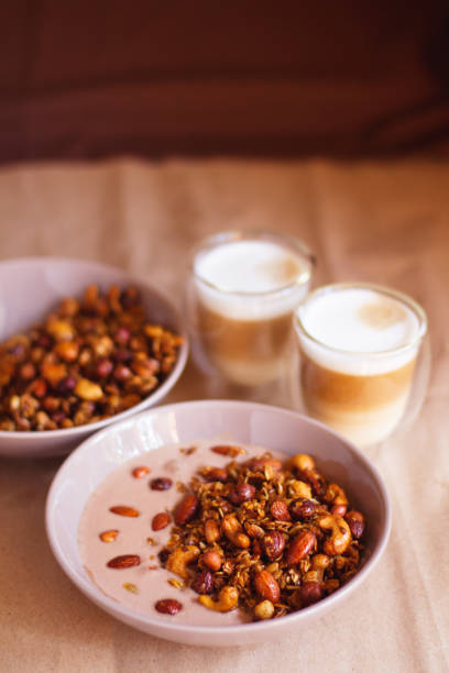 breakfast: granola with nuts and yogurt and coffee