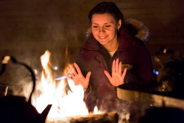 istock Happy woman relaxing at fireplace. Winter home. 856184516