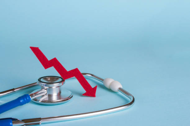 istock Prices are falling. Arrow diagram grows up near a stethoscope. Copy space for text 856184782