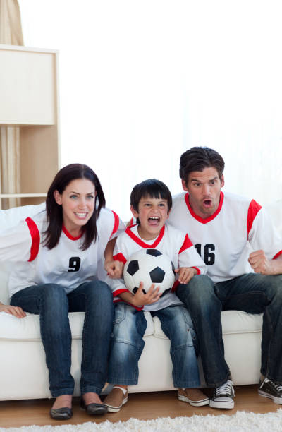 istock Animated family watching a football match 856185838