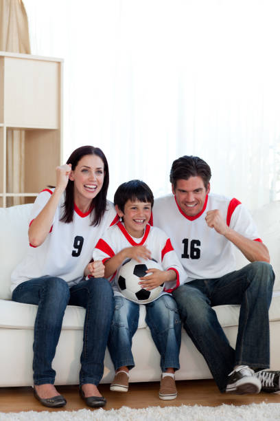 istock Lively famil ywatching football match 856186194