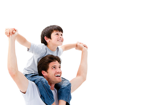 Joyful father giving piggyback ride to his son against a white background