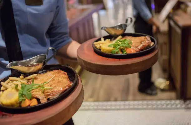 Waiter serving lunch