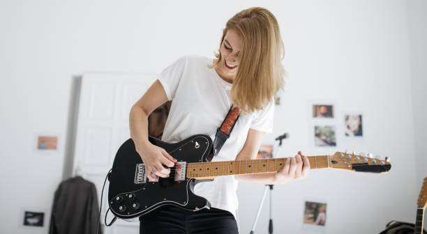 istock Beautiful woman playing electric guitar 856196690