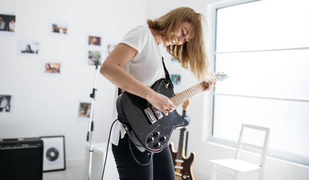 istock Pretty woman playing electric guitar 856196770