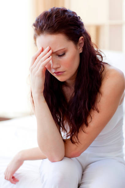 istock Beautiful woman having a headache in bed 856200252