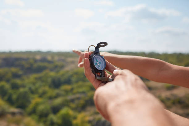 istock Traveler couple searching direction with a compass in summer mountains. Searching the way on canyon. 856200708