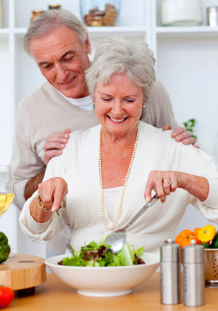 istock Happy senior couple eeating a salad in the kitchen 856203242