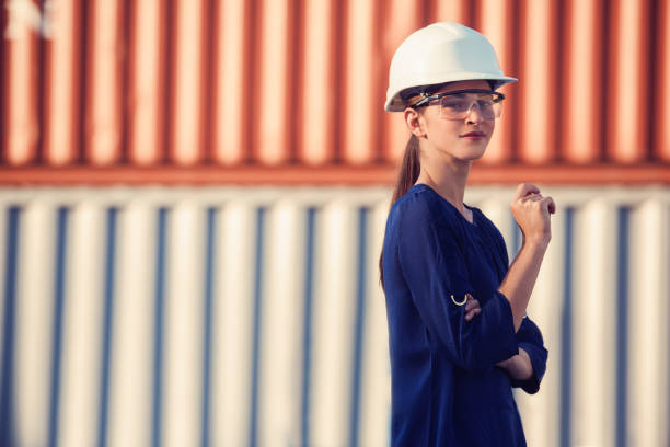 istock woman logistics engineer is standing in front of containers 856206390