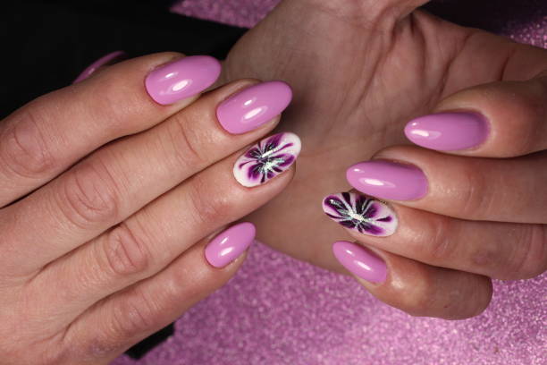 istock Manicure design purple with flower 856209034