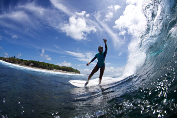 istock Surfer girl waves hello 856211546