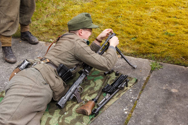 Spijk, Netherlands apr 17, 2016: German soldier assembling machine gun Spijk, Netherlands apr 17, 2016: Spijk terug naar toen event.German soldier assembling machine gun mg42 stock pictures, royalty-free photos & images