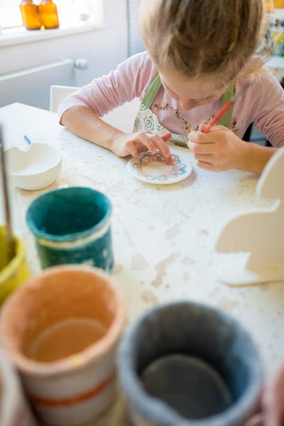 istock Girl Decorating clay pottery 856219878