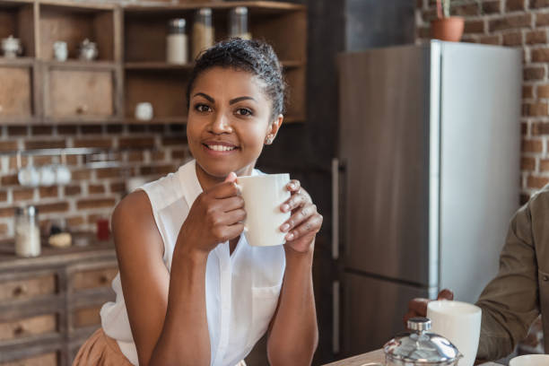 istock Smiling woman with cup of coffee 856222716