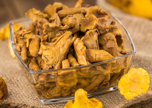 istock Portion of Preserved chanterelles on wooden background, selective focus 856223158