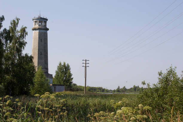 istock Old lighthouse on the overgrown shore in Dubna, Russian Federation 856226362