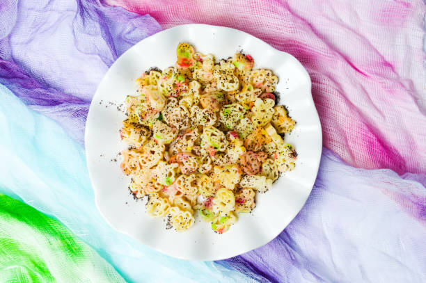 Colorful pasta with poppy seeds on a plate