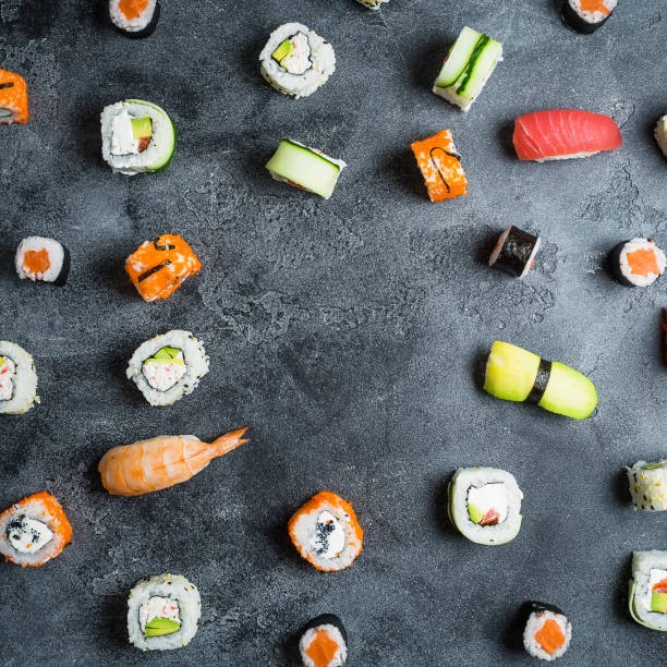 istock Pattern of sushi rolls on a dark background. Japanese food. Flat lay, top view 856229280