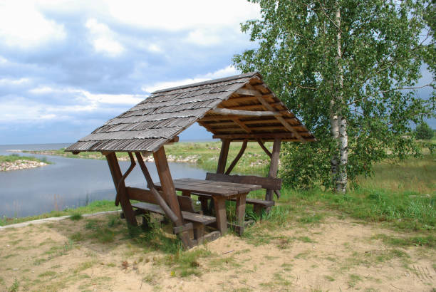 Equipped picnic place (wooden benches and canopy) on the lake shore.