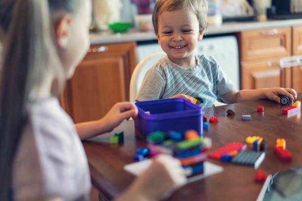 istock Two happy children playing with construction bricks at home. 856234874