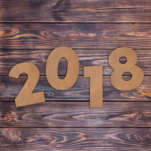 istock Cardstock Numbers 2018 Happy New Year Sign over table. 3d Rendering 856243078